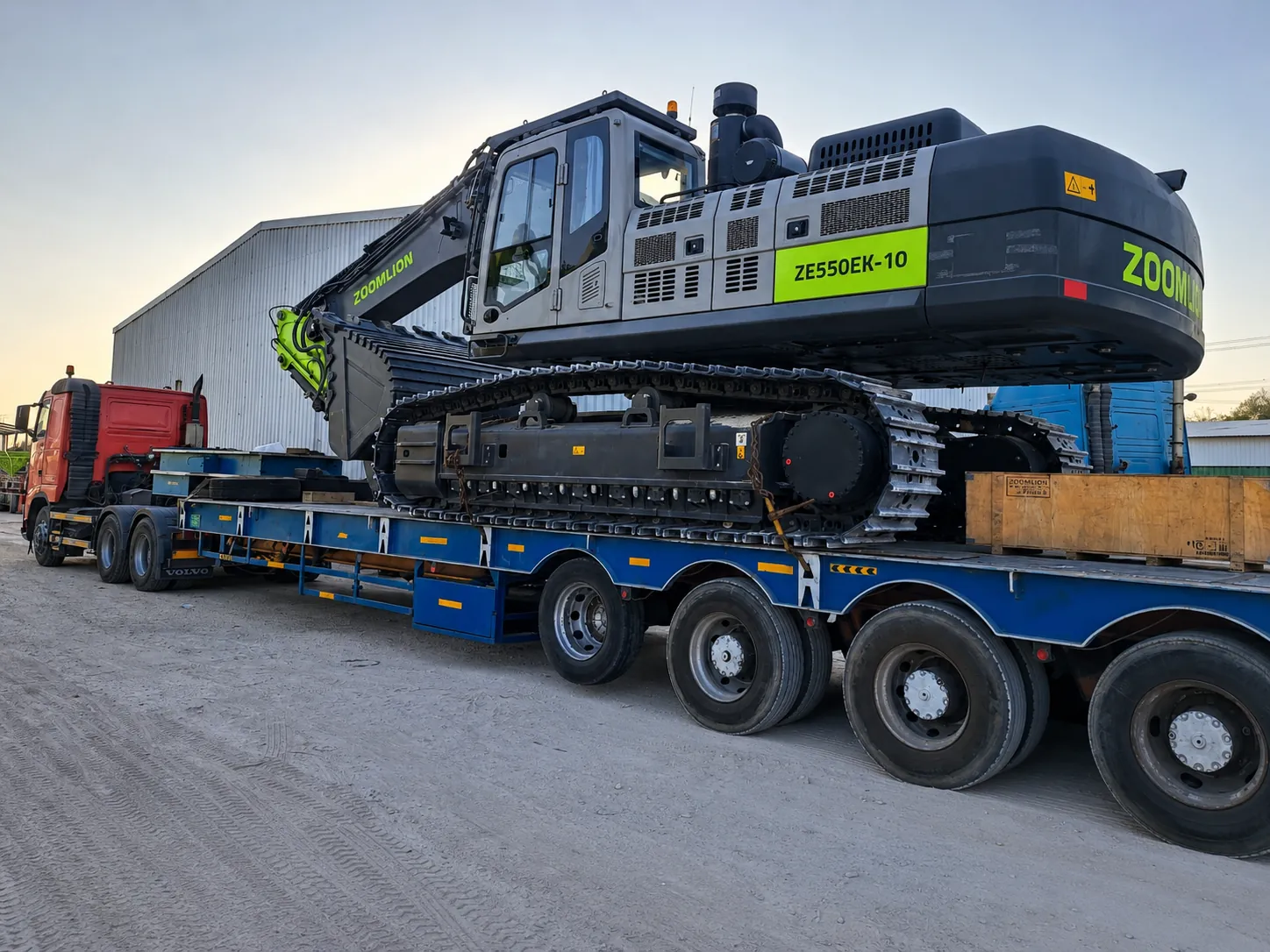 Zoomlion excavator transported on a lowbed trailer for heavy equipment logistics in the UAE