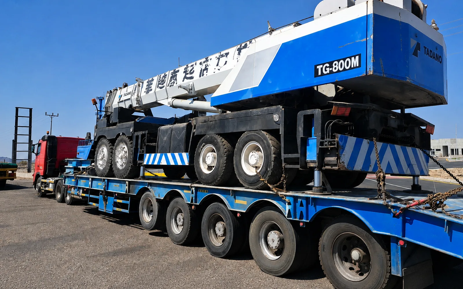 Tadano mobile crane secured on a lowbed trailer for heavy transport in the UAE