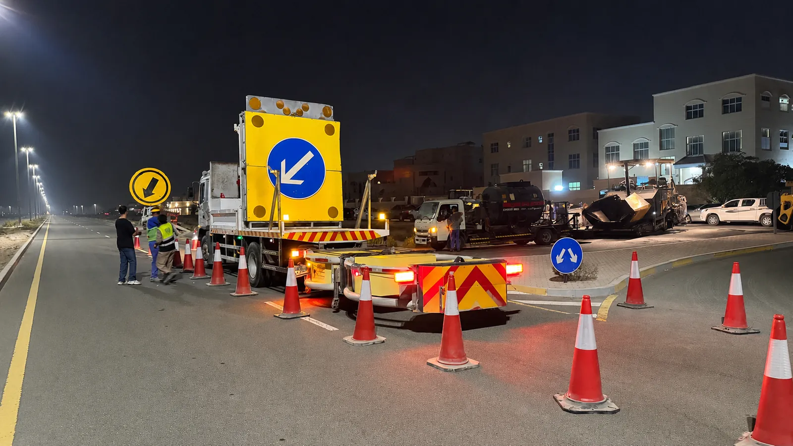 TMA vehicle, directional board and traffic cones protecting a nighttime roadworks zone in the UAE