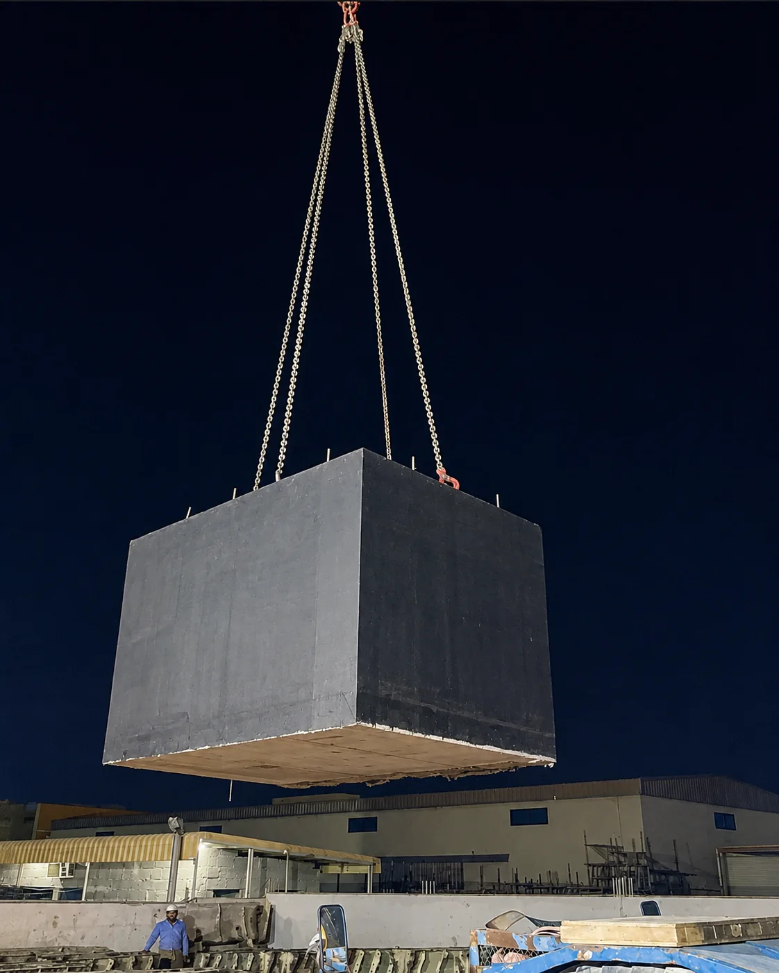 Large Precast Foundation Block Night Lifting UAE Large waterproofed precast concrete foundation block being lifted by crane during night operations