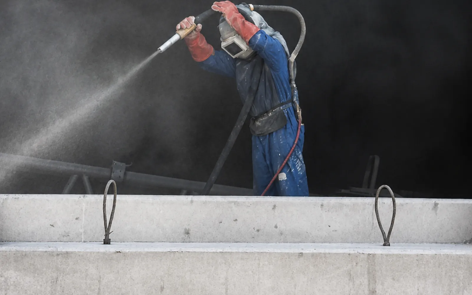 Precast Cable Chamber Surface Preparation in the UAE Worker preparing a precast cable chamber before utility installation in the UAE
