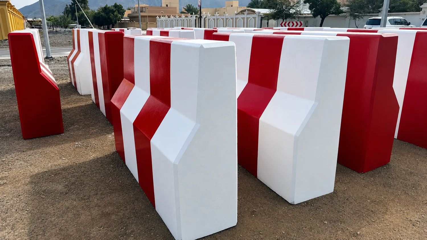 Bulk stock of red and white precast concrete barriers prepared for UAE projects