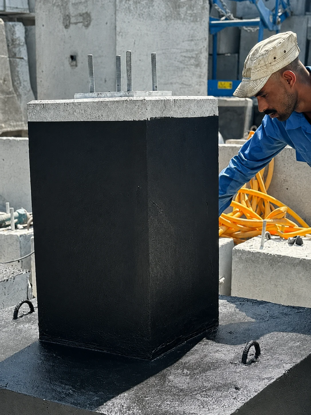 Precast concrete pole foundation pedestal with anchor bolts in a UAE precast facility
