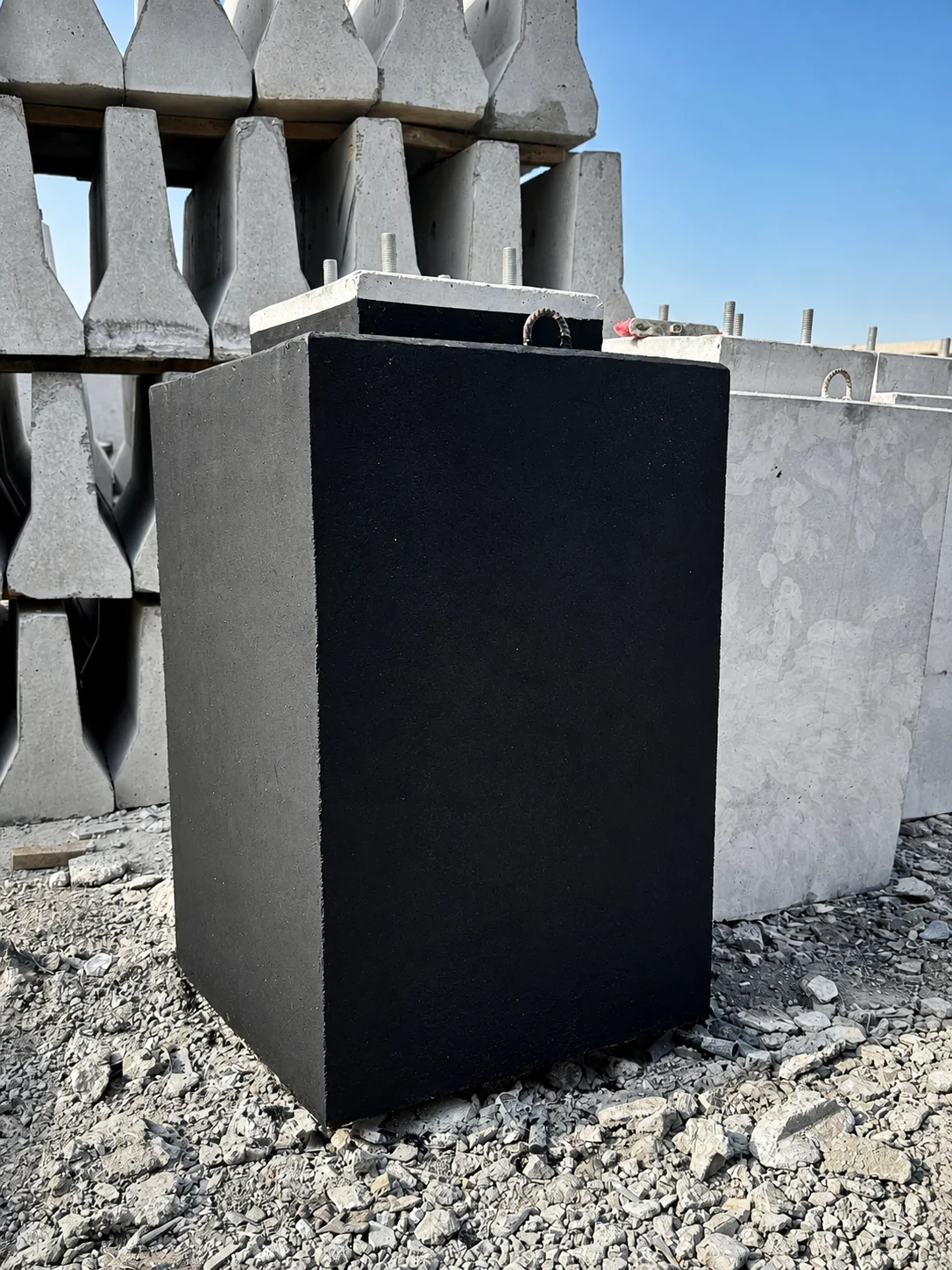 Protective-coated precast concrete light-pole foundation in a UAE precast yard